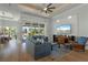 Open living area with sectional sofa, hardwood floors, and sliding glass doors at 2511 Rio Largo Ct, Punta Gorda, FL 33950