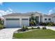 Modern home exterior with two-car garage and landscaped yard at 2511 Rio Largo Ct, Punta Gorda, FL 33950