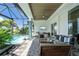 Covered patio with comfortable seating overlooking the pool at 2511 Rio Largo Ct, Punta Gorda, FL 33950