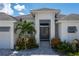 Modern house exterior with double doors and lush landscaping at 2511 Rio Largo Ct, Punta Gorda, FL 33950