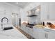 Modern kitchen with white cabinets, stainless steel appliances, and marble countertops at 2511 Rio Largo Ct, Punta Gorda, FL 33950