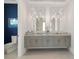 Double vanity bathroom with modern gray cabinets and stylish lighting at 2511 Rio Largo Ct, Punta Gorda, FL 33950