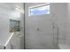Large shower with marble tile, built-in seat, and rain shower head at 2511 Rio Largo Ct, Punta Gorda, FL 33950