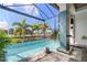 Relaxing pool area with water feature and screened enclosure at 2511 Rio Largo Ct, Punta Gorda, FL 33950