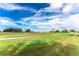 View of a lush green golf course with a paved pathway at 1211 Saxony Cir # B1, Punta Gorda, FL 33983