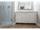 Contemporary bathroom with double sink vanity, drawers, shower and wood-look floors at 2000 Bal Harbor Blvd # 1012, Punta Gorda, FL 33950