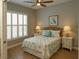 Bedroom with a starfish themed decor, ceiling fan, shutters and wood look floors at 2000 Bal Harbor Blvd # 1012, Punta Gorda, FL 33950