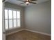 Bedroom with a ceiling fan, plantation shutters and wood look floors at 2000 Bal Harbor Blvd # 1012, Punta Gorda, FL 33950