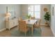 Cozy dining room with a wooden table, wicker chairs, and bright window at 2000 Bal Harbor Blvd # 1012, Punta Gorda, FL 33950