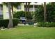 Outdoor grilling area with a stainless steel grill and a picnic table surrounded by lush landscaping at 2000 Bal Harbor Blvd # 1012, Punta Gorda, FL 33950