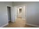 View of the interior with multiple doorways, hardwood floors, and a washer/dryer in the background at 2000 Bal Harbor Blvd # 1012, Punta Gorda, FL 33950