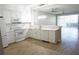 Modern kitchen featuring white cabinets, stainless steel appliances, and an open layout to the living area at 2000 Bal Harbor Blvd # 1012, Punta Gorda, FL 33950
