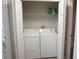 Functional laundry room with a washer and dryer behind white folding doors at 2000 Bal Harbor Blvd # 1012, Punta Gorda, FL 33950