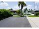 View of the parking area with a canal, boat dock, and tropical landscaping in a waterfront community at 2000 Bal Harbor Blvd # 1012, Punta Gorda, FL 33950