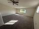 Spacious primary bedroom with plush carpeting and large windows at 240 Cicero Nw St, Port Charlotte, FL 33948