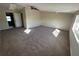 Large primary bedroom with carpeting and ensuite bathroom access at 240 Cicero Nw St, Port Charlotte, FL 33948