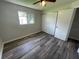 Bright bedroom with wood-look floors and ample closet space at 240 Cicero Nw St, Port Charlotte, FL 33948