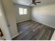 Bedroom with wood-look laminate flooring and ceiling fan at 240 Cicero Nw St, Port Charlotte, FL 33948