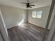 Well-lit bedroom featuring wood-look floors and a ceiling fan at 240 Cicero Nw St, Port Charlotte, FL 33948