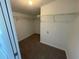 Large walk-in closet with wire shelving and neutral carpeting at 240 Cicero Nw St, Port Charlotte, FL 33948
