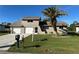 Tan two-story house with a two-car garage and palm tree at 240 Cicero Nw St, Port Charlotte, FL 33948