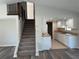 Open kitchen with white cabinets and view of the stairs at 240 Cicero Nw St, Port Charlotte, FL 33948