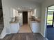 Bright kitchen with white cabinets and access to the patio at 240 Cicero Nw St, Port Charlotte, FL 33948