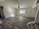 Living room with laminate floors and access to the stairs at 240 Cicero Nw St, Port Charlotte, FL 33948