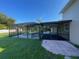 Enclosed pool area with patio and grassy yard at 240 Cicero Nw St, Port Charlotte, FL 33948