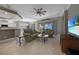 Open living room with large TV, comfortable sofas, and views of the golf course at 3959 San Rocco Ct # 911, Punta Gorda, FL 33950