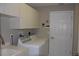 Laundry room with washer, dryer, cabinets, and a sink at 3959 San Rocco Ct # 911, Punta Gorda, FL 33950