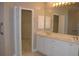 Double vanity bathroom with large mirror and walk-in closet at 3959 San Rocco Ct # 911, Punta Gorda, FL 33950