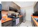 Stainless steel appliances and orange countertops in this kitchen at 335 Kenova St, Port Charlotte, FL 33954
