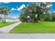 Charming house exterior with a grassy yard and driveway at 335 Kenova St, Port Charlotte, FL 33954