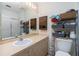 Clean bathroom with vanity, toilet, and storage shelving at 335 Kenova St, Port Charlotte, FL 33954