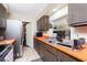 Orange countertops and stainless steel appliances highlight this kitchen at 335 Kenova St, Port Charlotte, FL 33954