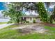 Single-story house exterior, featuring a covered entryway and landscaping at 335 Kenova St, Port Charlotte, FL 33954