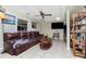 Living room with leather couch, coffee table, and shelving at 335 Kenova St, Port Charlotte, FL 33954