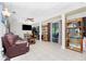 Living room with leather couches, tiled floors and built-in shelving at 335 Kenova St, Port Charlotte, FL 33954