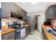 Kitchen boasts stainless steel appliances and orange countertops at 335 Kenova St, Port Charlotte, FL 33954