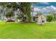 Tan house exterior with lush landscaping and driveway at 335 Kenova St, Port Charlotte, FL 33954