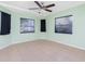 Bright bedroom with tile floors, ceiling fan, and large windows at 335 Kenova St, Port Charlotte, FL 33954