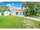 Tan house exterior with green landscaping and driveway at 335 Kenova St, Port Charlotte, FL 33954
