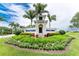 Heritage Landing entrance with lush landscaping and signage at 14071 Heritage Landing Blvd # 327, Punta Gorda, FL 33955