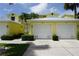 Bright yellow two-story building with attached garages at 2000 Bal Harbor Blvd # 1012, Punta Gorda, FL 33950