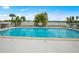 Community pool with lake view and ample space at 26283 Nadir Rd # 201, Punta Gorda, FL 33983