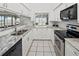 Modern kitchen featuring granite countertops, white cabinets, and stainless steel appliances at 26283 Nadir Rd # 201, Punta Gorda, FL 33983