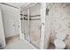 Bathroom with shower stall and bamboo-print wallpaper at 26283 Nadir Rd # 201, Punta Gorda, FL 33983