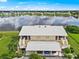 Aerial view of condo with lake view, two-car garage, and community at 26283 Nadir Rd # 201, Punta Gorda, FL 33983