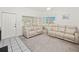 Living room with two reclining sofas and neutral color palette at 26283 Nadir Rd # 201, Punta Gorda, FL 33983